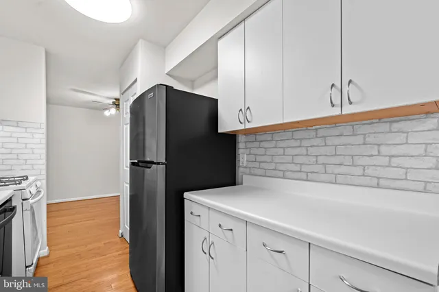 a kitchen with a refrigerator and a stove