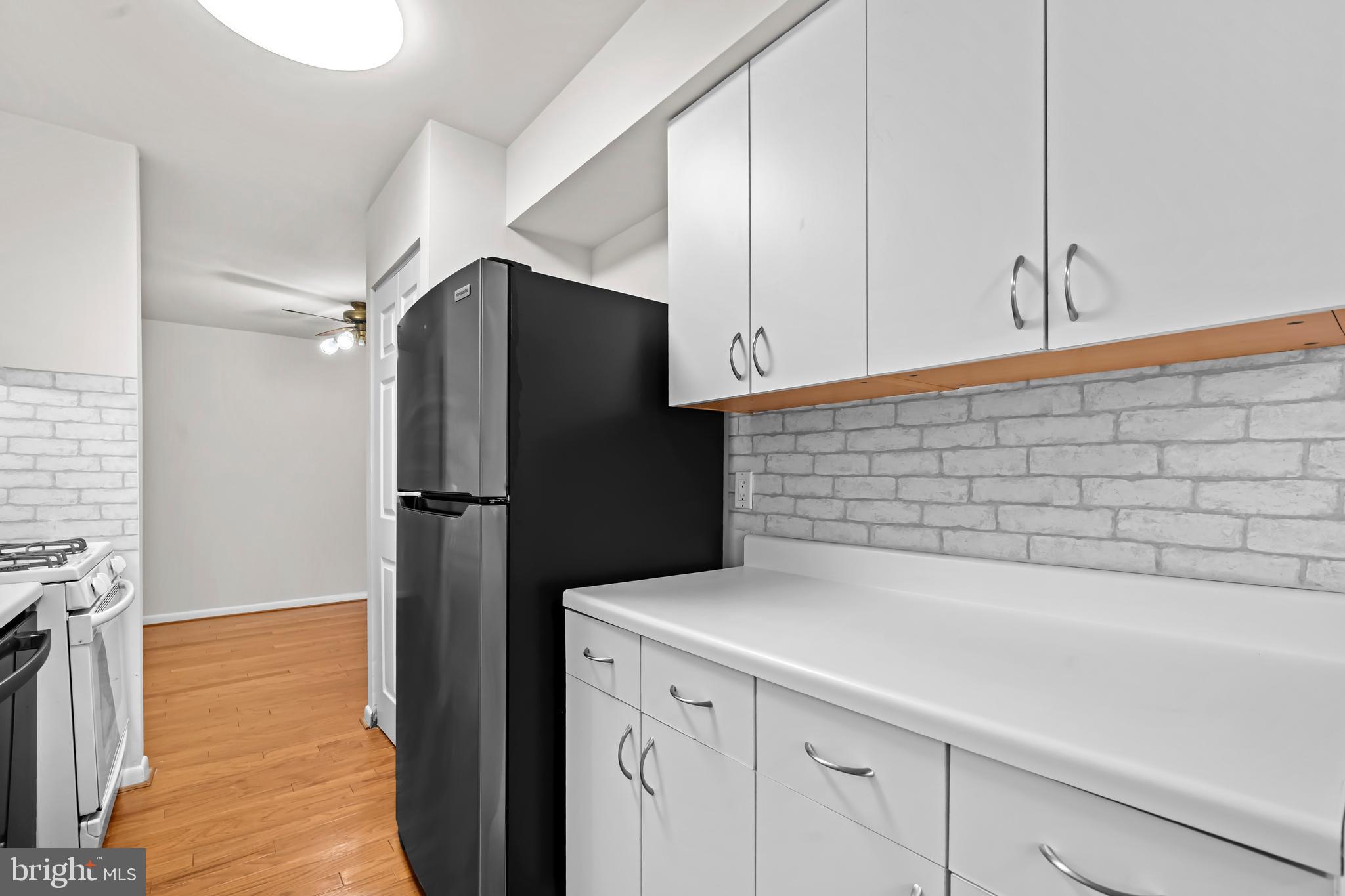 11200 Chestnut Grove Square, Unit 203 Reston, VA 20190 - Photo 17 of 41 a kitchen with a refrigerator and a stove