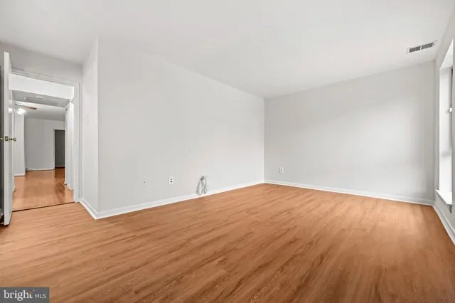 a view of an empty room and wooden floor