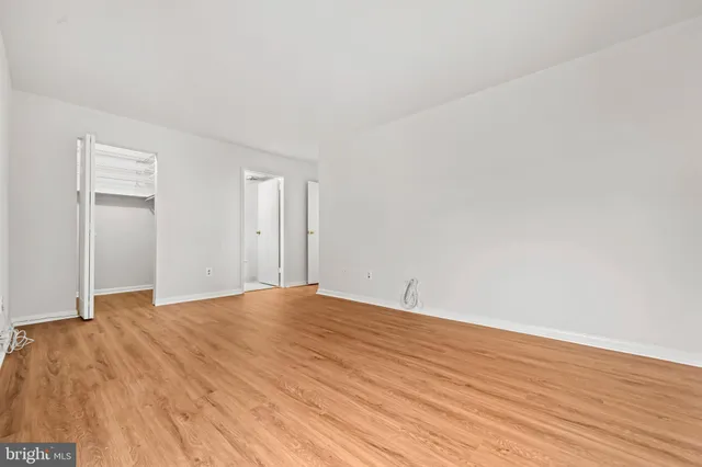 a view of an empty room and wooden floor