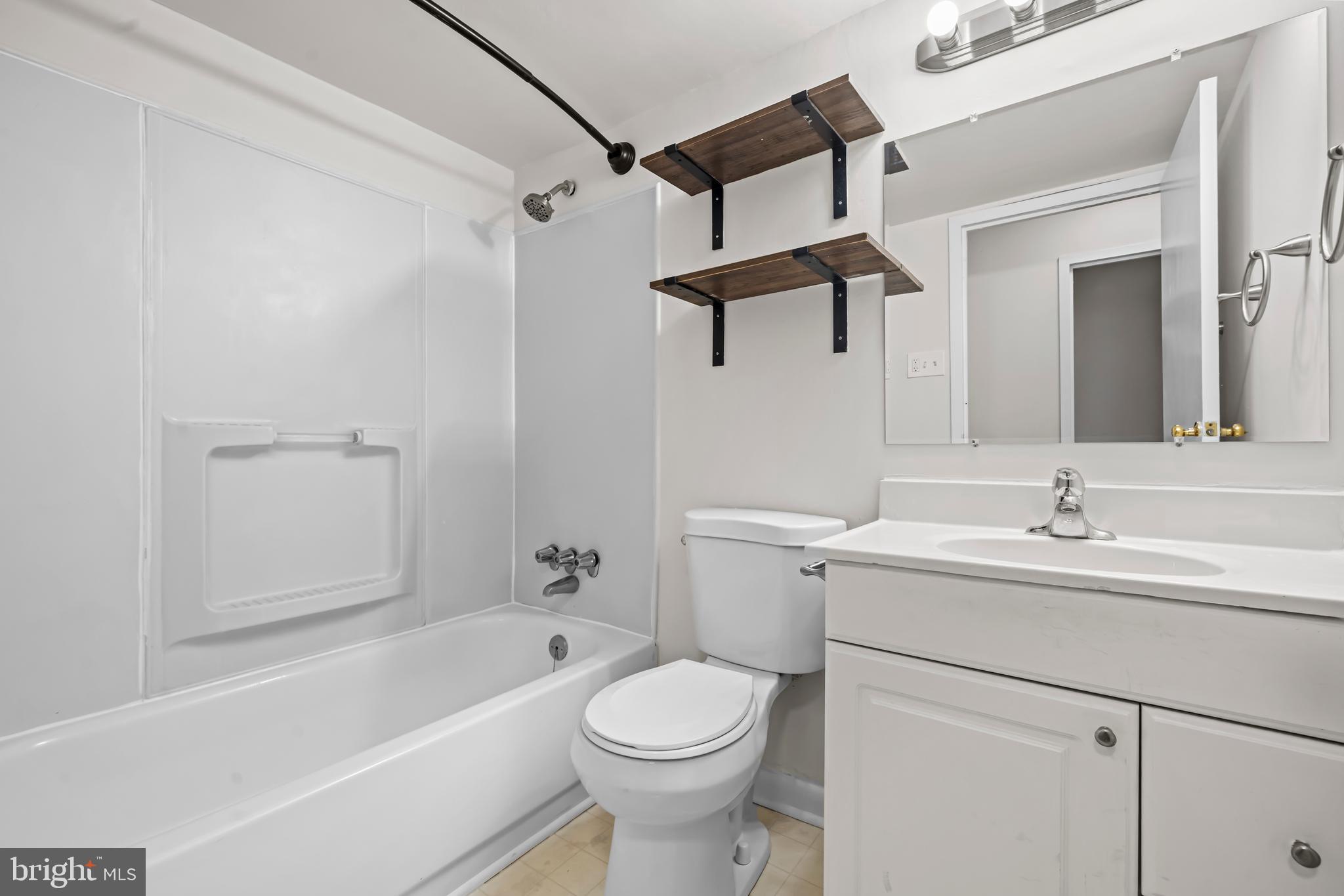 11200 Chestnut Grove Square, Unit 203 Reston, VA 20190 - Photo 31 of 41 a bathroom with a sink a toilet and shower