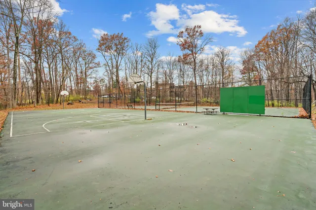 a view of a playground with basketball court