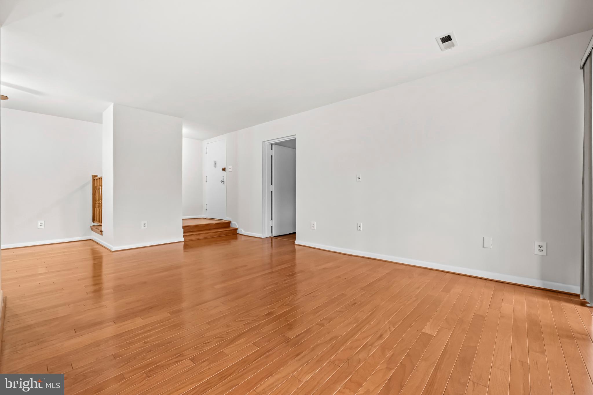 11200 Chestnut Grove Square, Unit 203 Reston, VA 20190 - Photo 4 of 41 a view of empty room with wooden floor