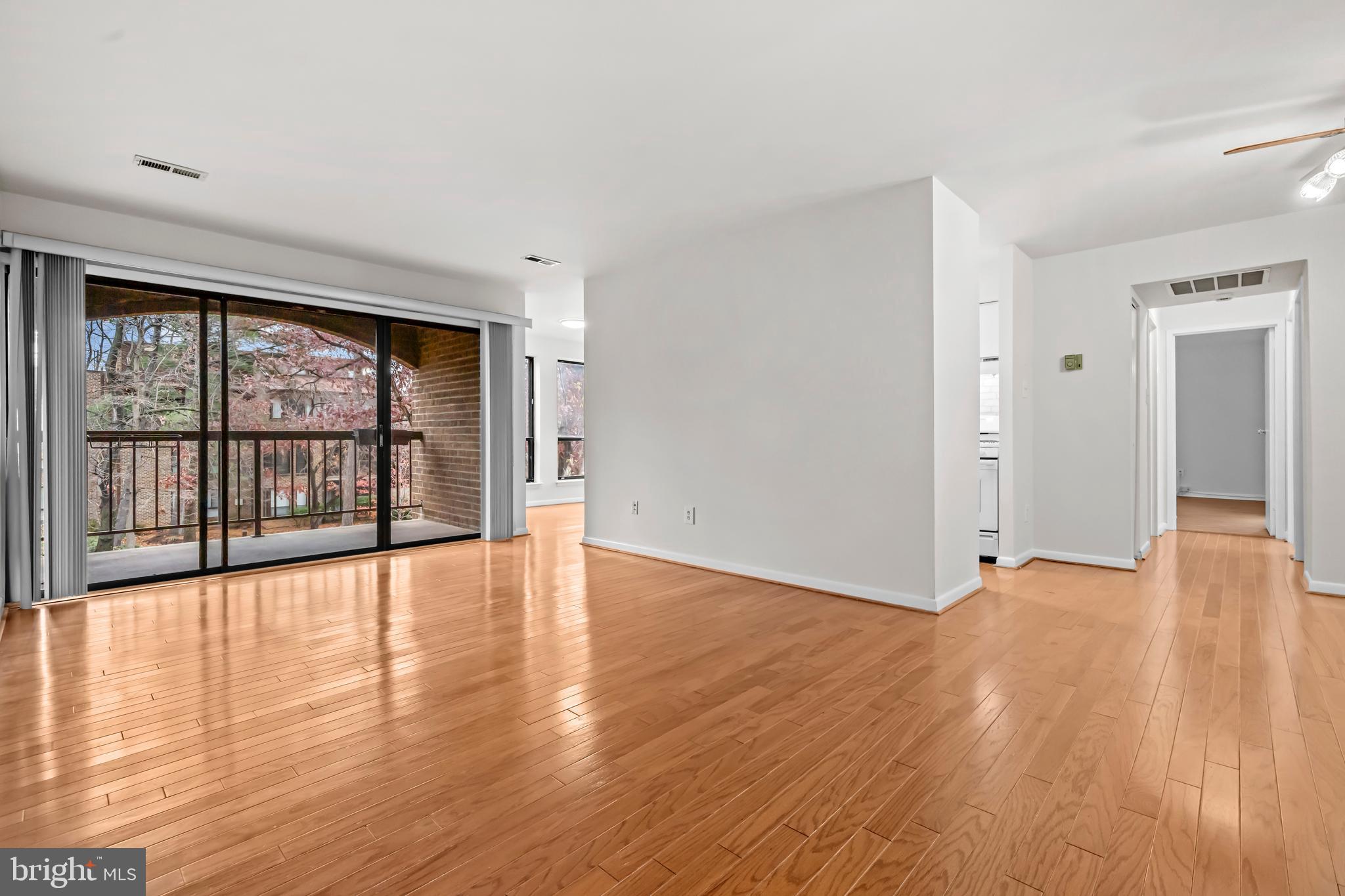 11200 Chestnut Grove Square, Unit 203 Reston, VA 20190 - Photo 5 of 41 wooden floor in an empty room with a window