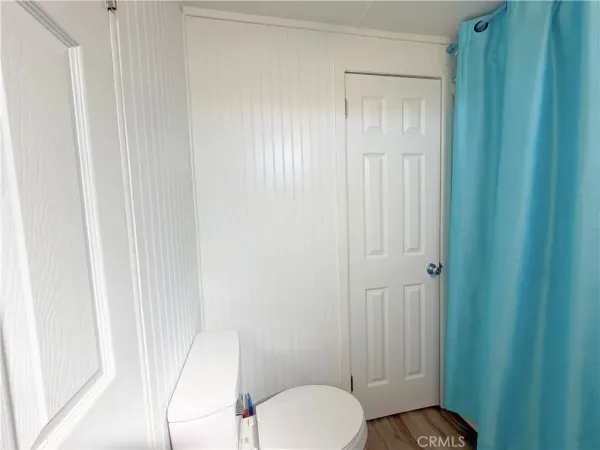 a bathroom with a toilet and a shower