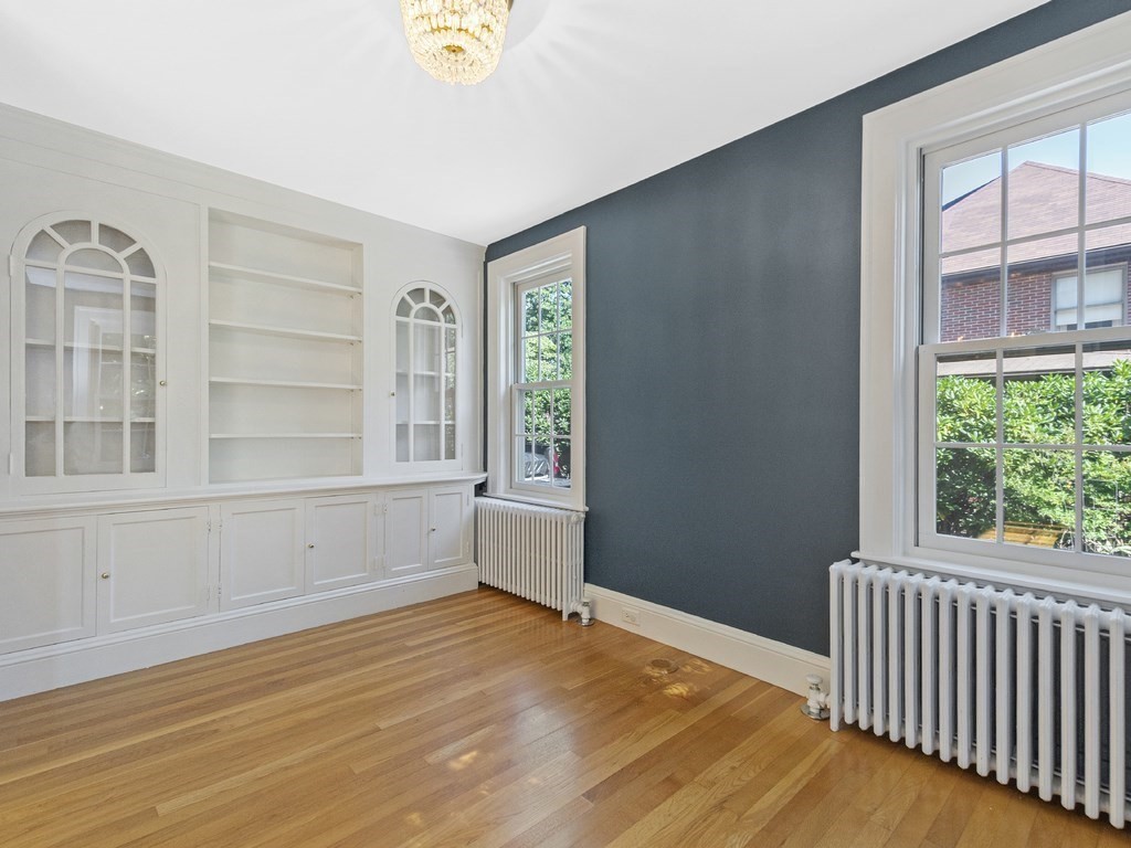 9 Larch Road Newton, MA 02468 - Photo 14 of 34 an empty room with wooden floor and windows