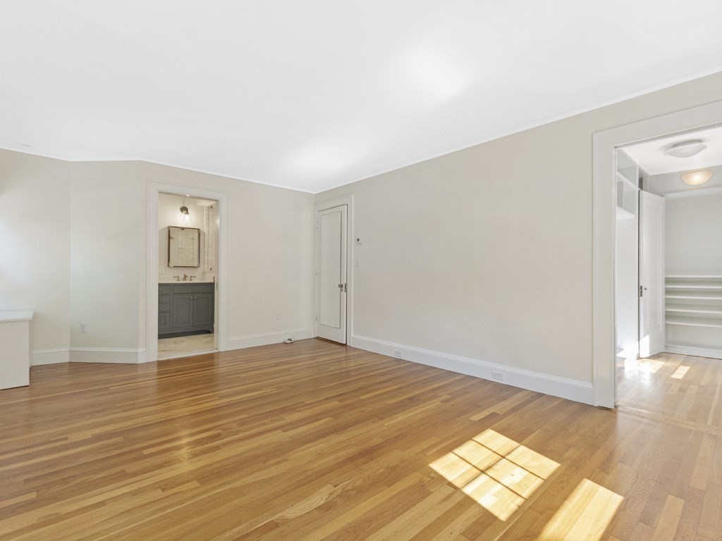 9 Larch Road Newton, MA 02468 - Photo 16 of 34 a view of an empty room with wooden floor and a window