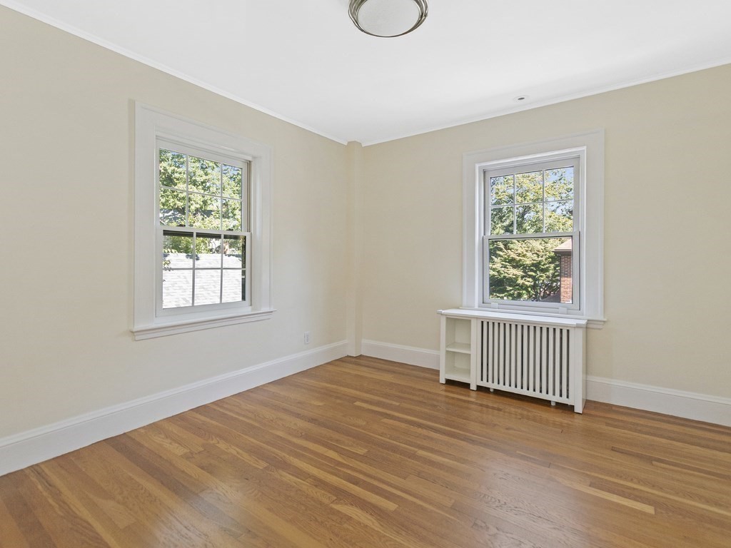 9 Larch Road Newton, MA 02468 - Photo 17 of 34 a view of an empty room with wooden floor and a window