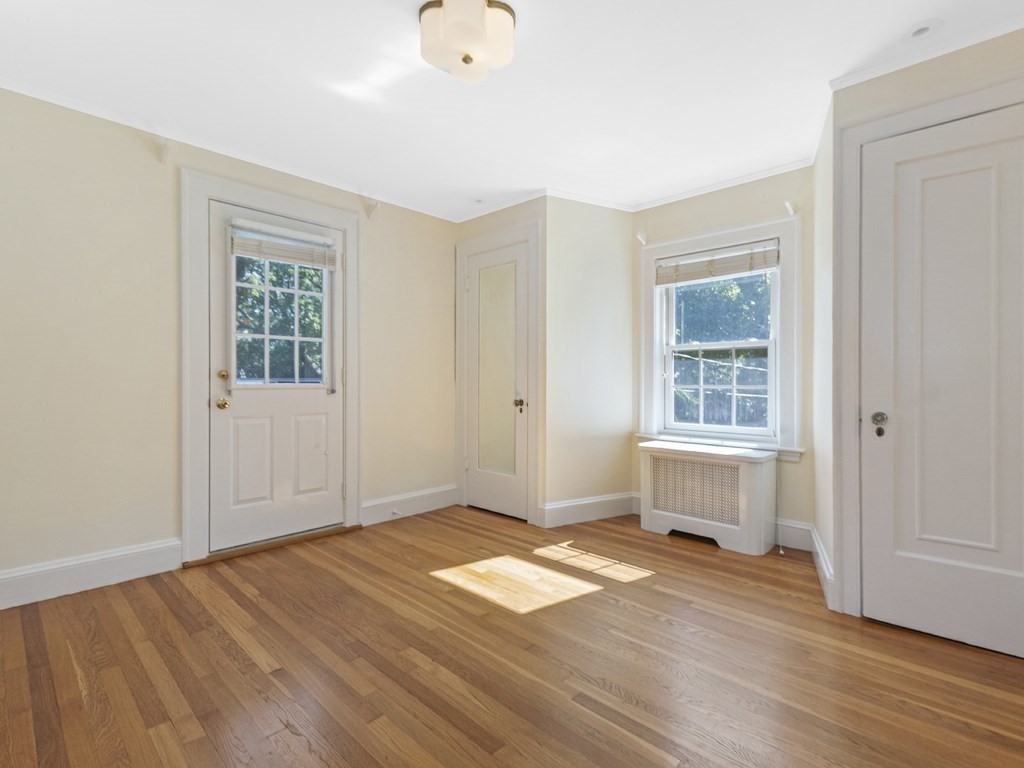 9 Larch Road Newton, MA 02468 - Photo 18 of 34 an empty room with wooden floor and windows