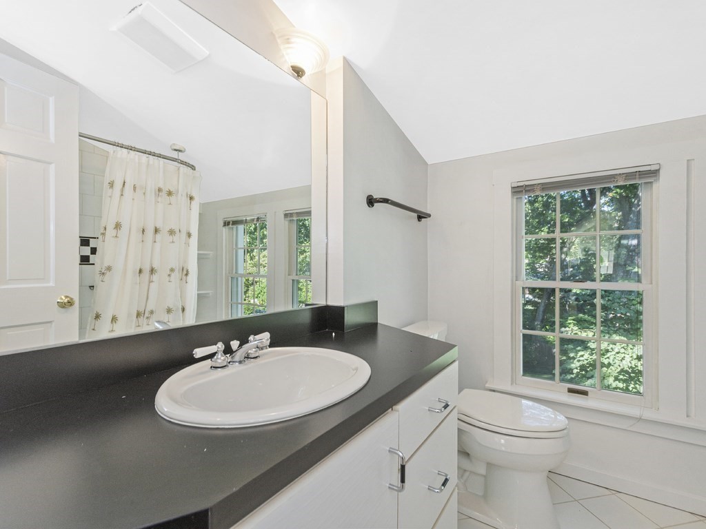 9 Larch Road Newton, MA 02468 - Photo 24 of 34 a bathroom with a sink and a mirror