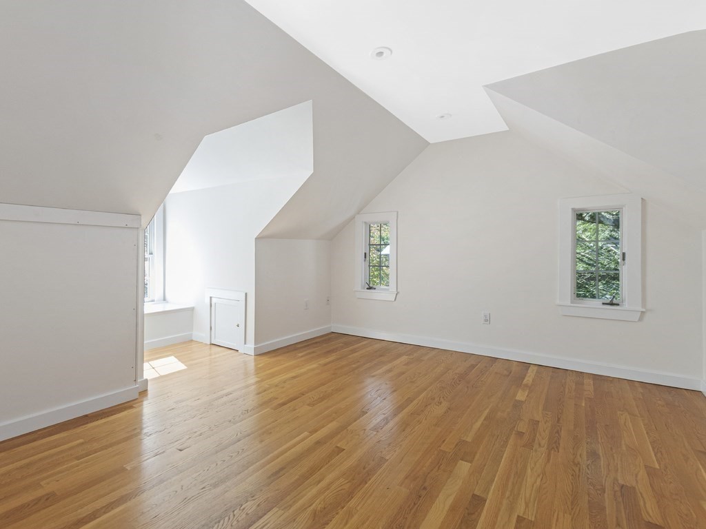 9 Larch Road Newton, MA 02468 - Photo 26 of 34 a view of a big room with wooden floor and windows