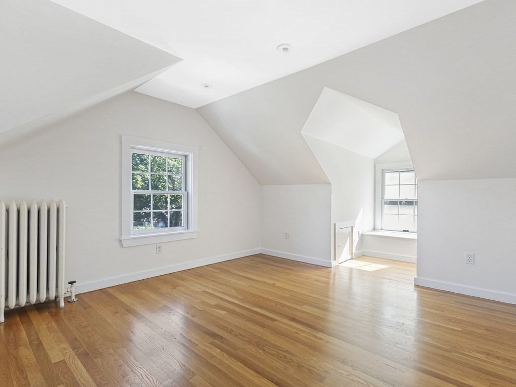 9 Larch Road Newton, MA 02468 - Photo 27 of 34 an empty room with wooden floor and windows