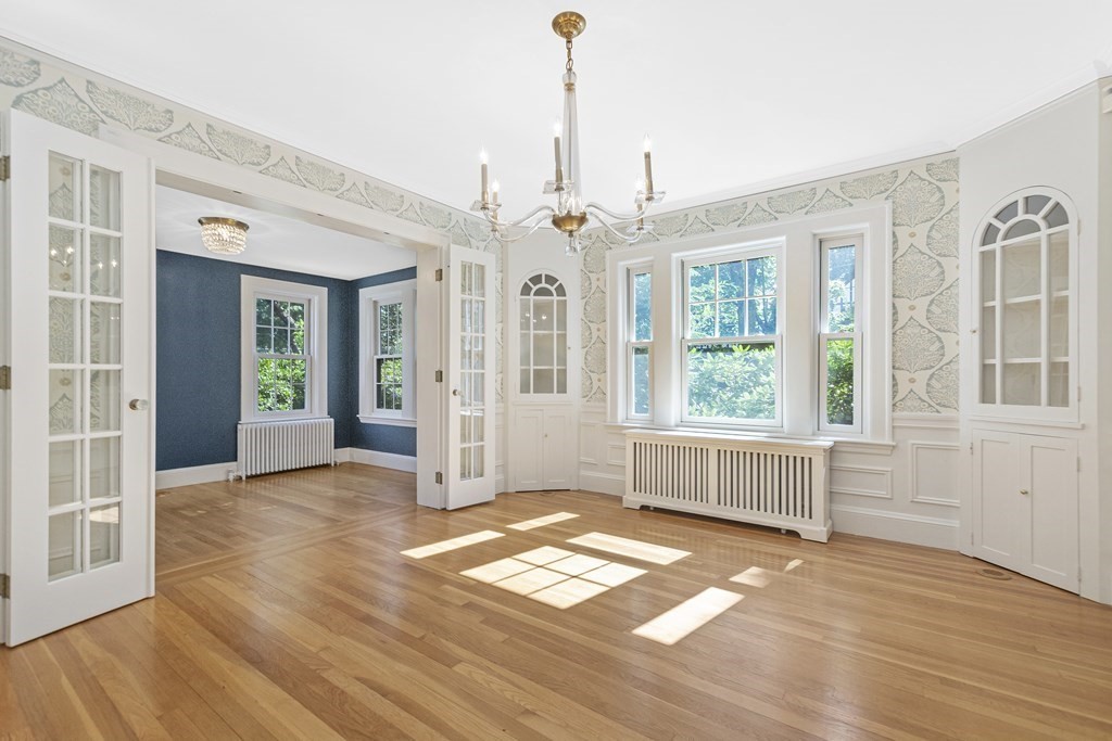 9 Larch Road Newton, MA 02468 - Photo 6 of 34 an empty room with wooden floor and windows