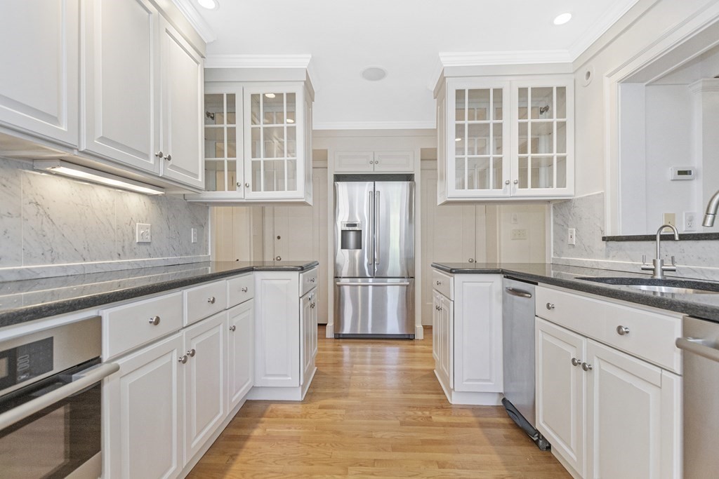 9 Larch Road Newton, MA 02468 - Photo 10 of 34 a kitchen with stainless steel appliances granite countertop a refrigerator and cabinets