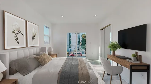 a bedroom with a bed and a flat screen tv