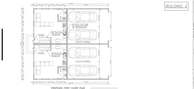an aerial view of residential houses with outdoor space and parking