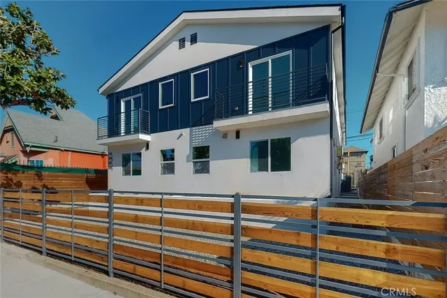 a front view of a house with windows and garage