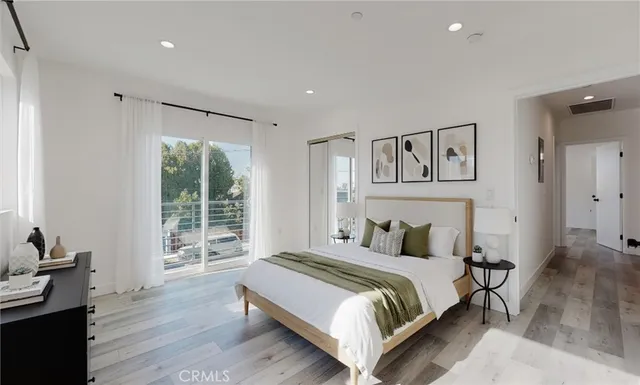 a bedroom with a bed and wooden floor