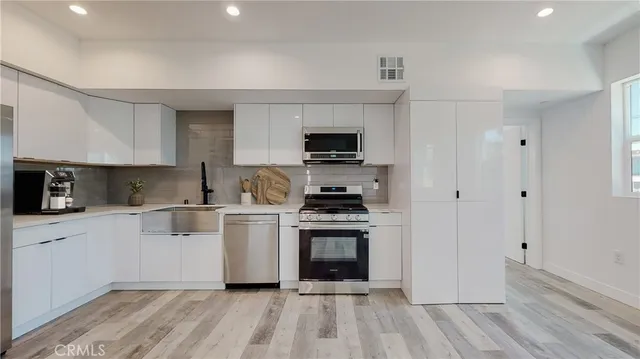 a kitchen with a stove a sink and a refrigerator