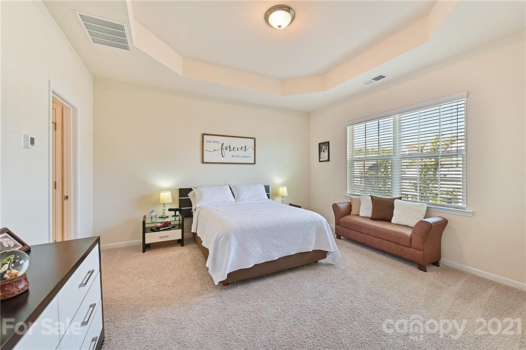 4032 Whittier Lane Fort Mill, SC 29708 - Photo 22 of 34 a spacious bedroom with a bed and a couch