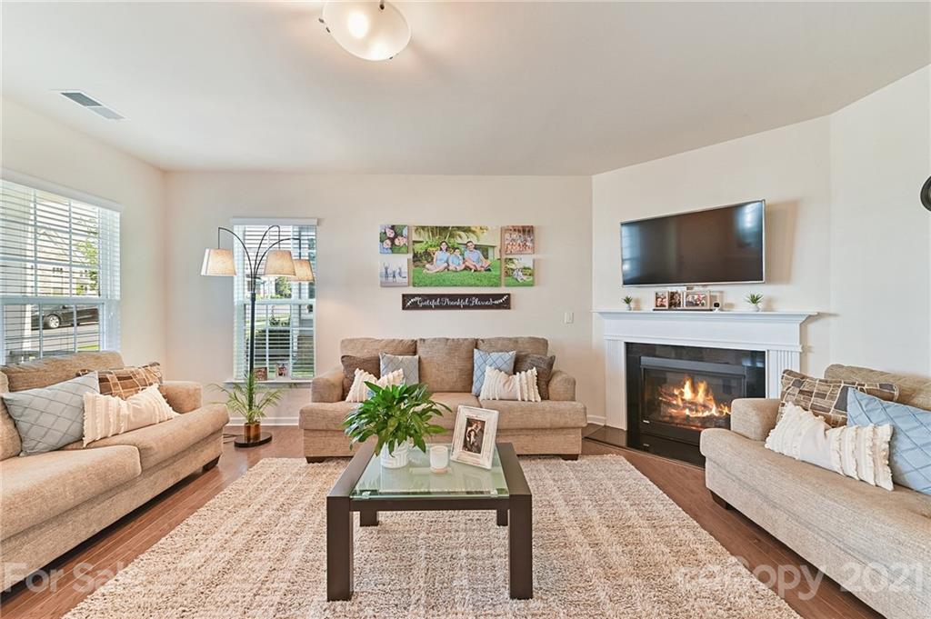 4032 Whittier Lane Fort Mill, SC 29708 - Photo 8 of 34 a living room with furniture a flat screen tv and a fireplace
