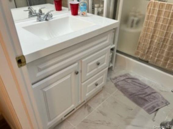 1661 Old Country Road, Unit 166 Riverhead, NY 11901 - Photo 4 of 7 a bathroom with a sink and a mirror