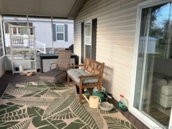 1661 Old Country Road, Unit 166 Riverhead, NY 11901 - Photo 6 of 7 a living room with furniture and wooden floor