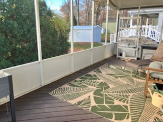 1661 Old Country Road, Unit 166 Riverhead, NY 11901 - Photo 7 of 7 a view of balcony with wooden floor