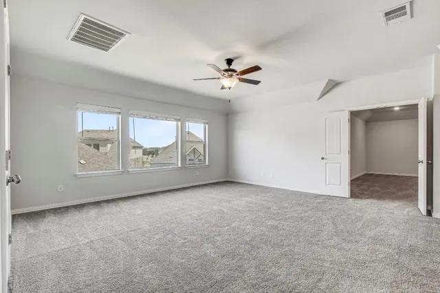 an empty room with windows and closet