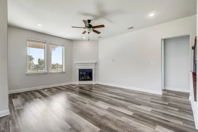 an empty room with windows and a fireplace