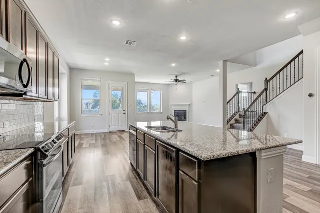 a kitchen with sink cabinets and wooden floor
