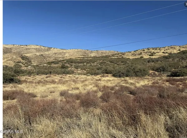 a view of a large mountain with mountains in the background