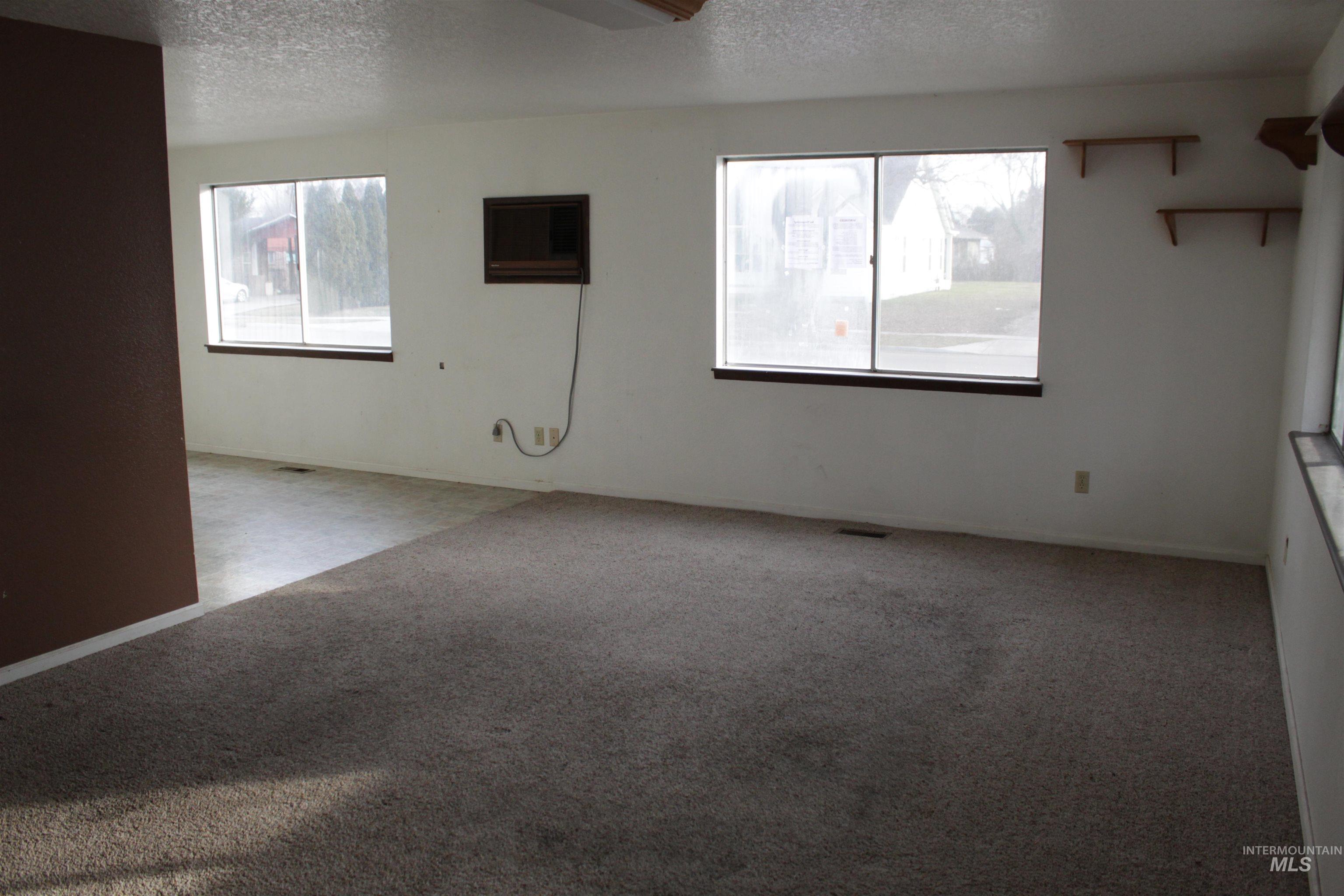 622 East Court Street Weiser, ID 83672 - Photo 2 of 20 Empty room with a textured ceiling and carpet flooring