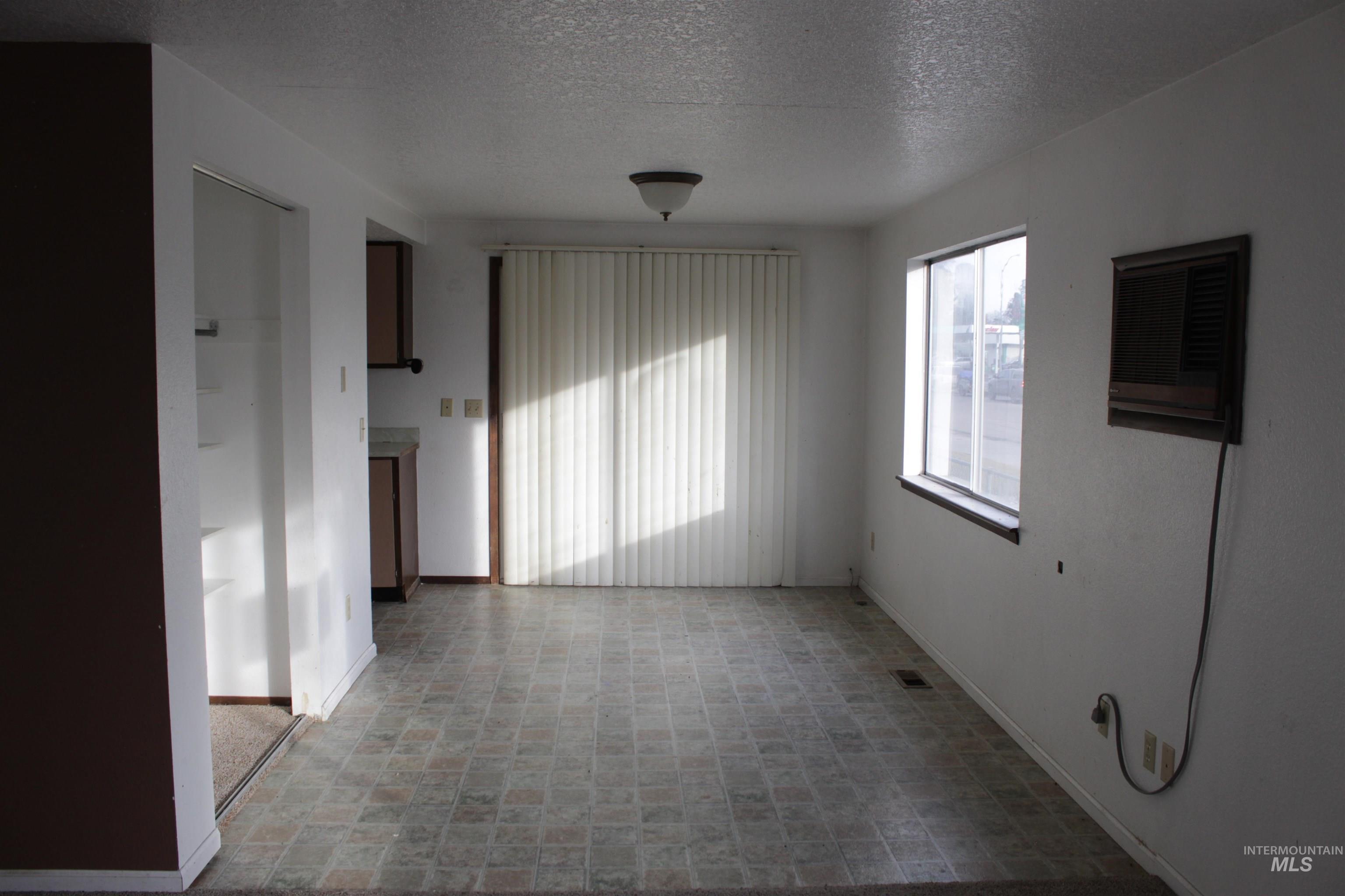 622 East Court Street Weiser, ID 83672 - Photo 3 of 20 Unfurnished room with a textured ceiling and baseboards
