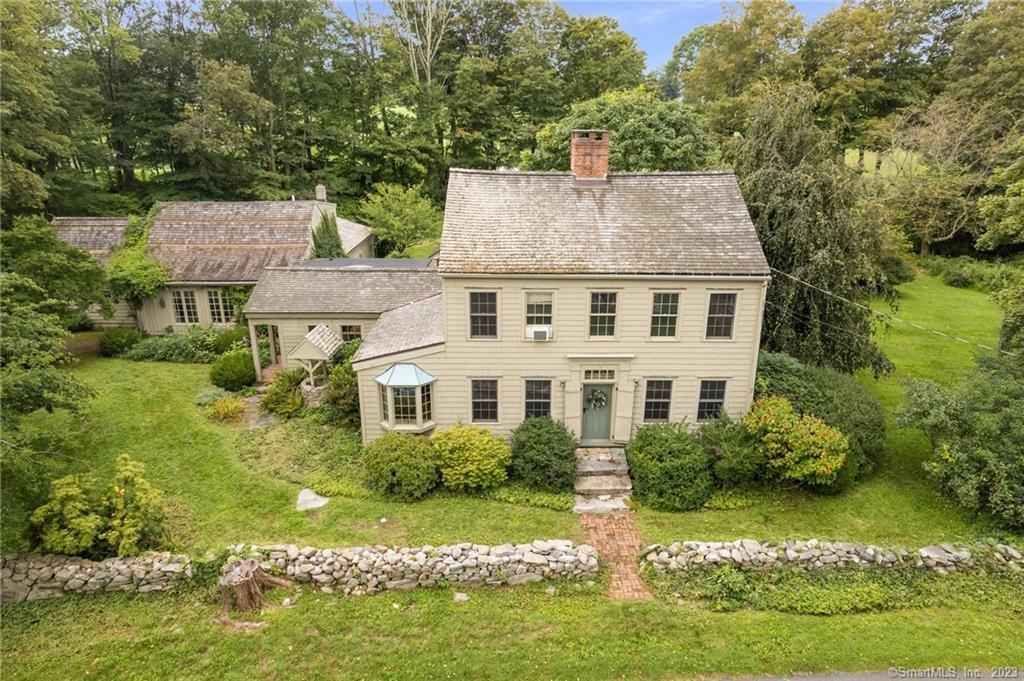 a aerial view of a house with a yard table and chairs