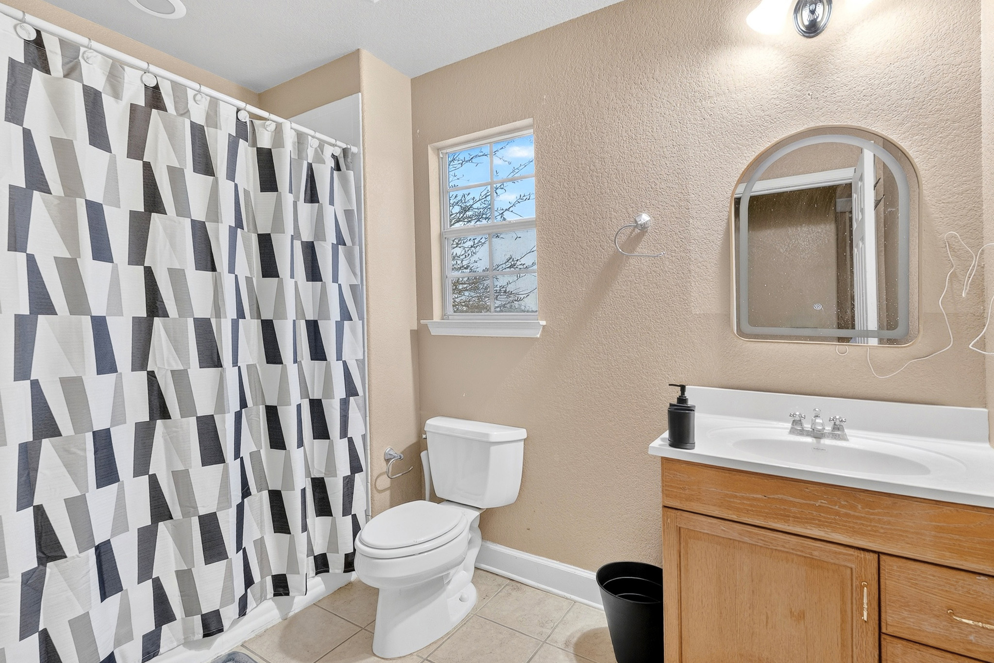 3811 Hawk View Street Round Rock, TX 78665 - Photo 10 of 20 a bathroom with a toilet a sink and a mirror
