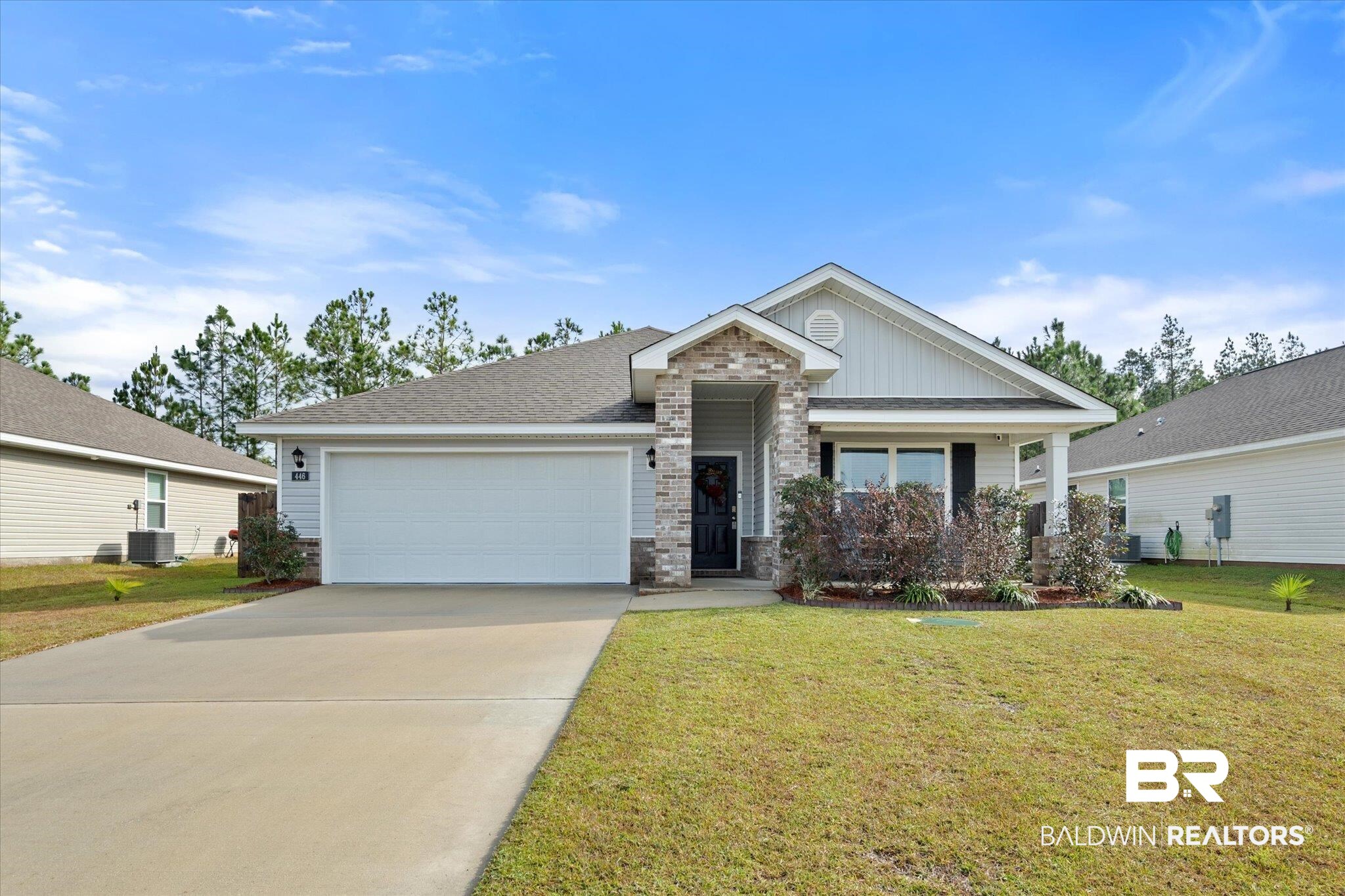 446 Paget Drive East Mobile, AL 36608 - Photo 1 of 20 View of front of home featuring central AC, a front lawn, and a garage