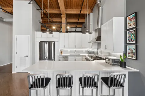a kitchen with stainless steel appliances a stove a sink and a refrigerator