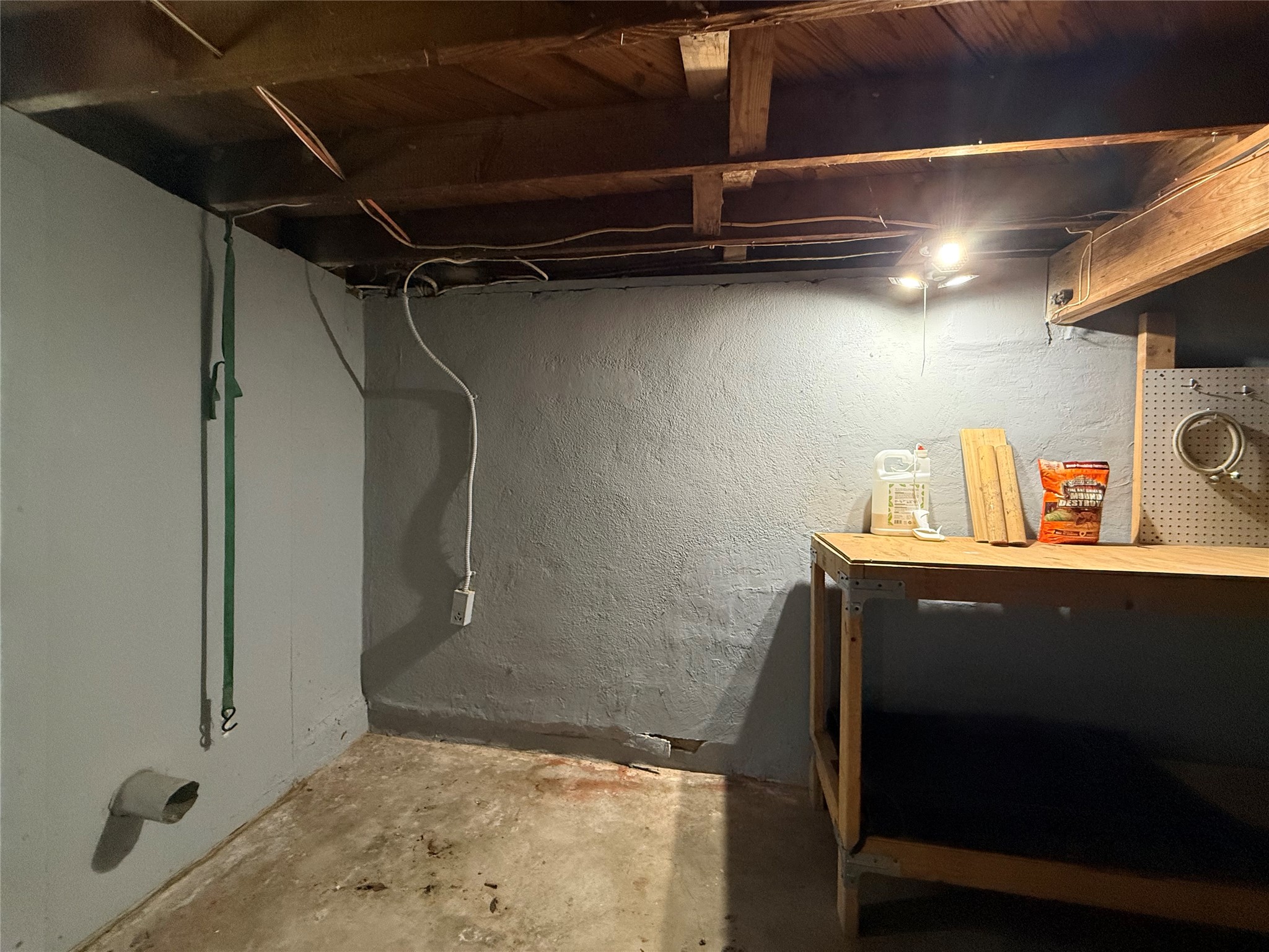 3305 Merrie Lynn Avenue Austin, TX 78722 - Photo 21 of 22 An unfinished basement with exposed wooden beams, offering utilitarian storage solutions.