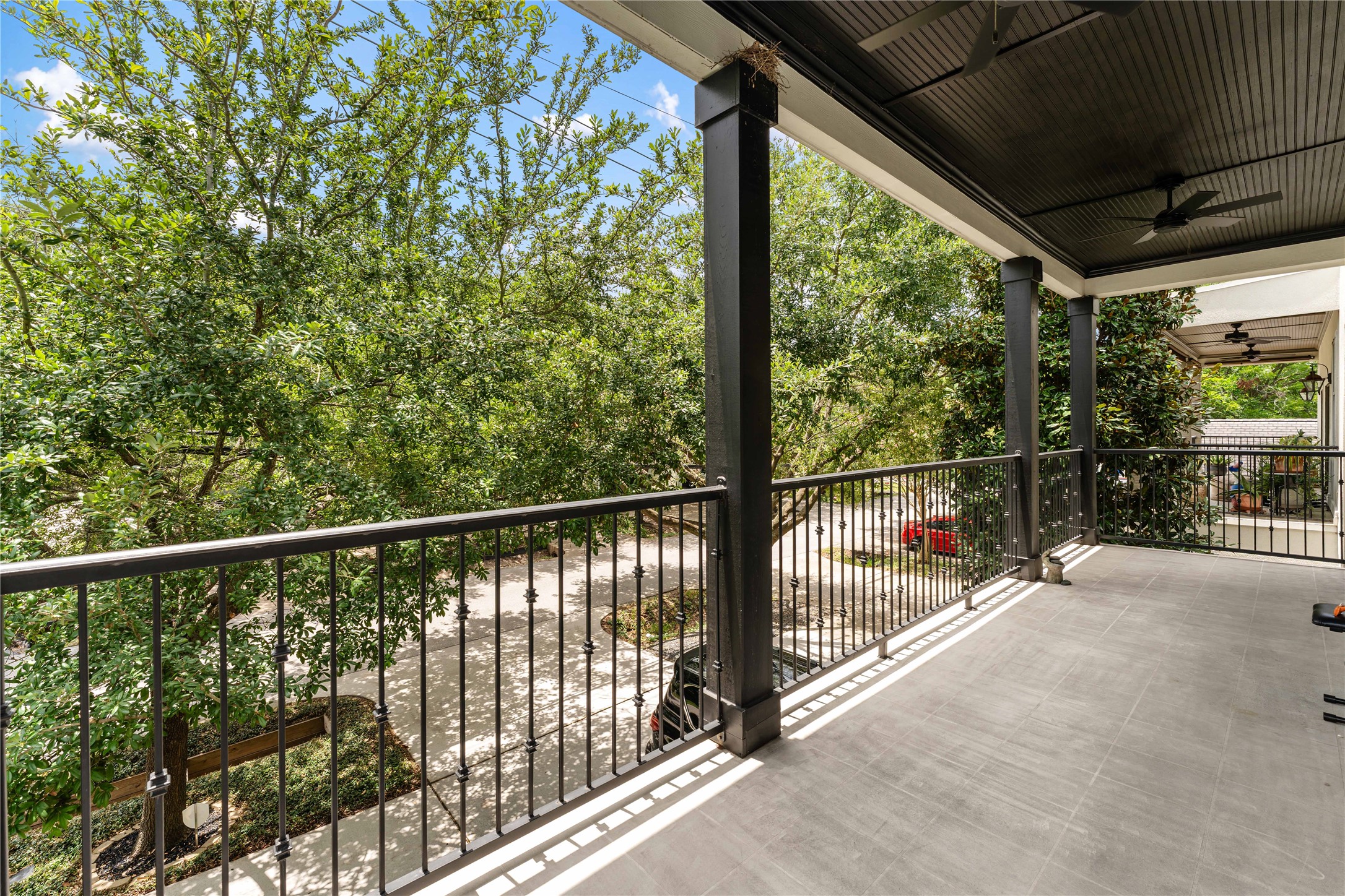 415 West 8th Street Houston, TX 77007 - Photo 23 of 39 Designed for effortless entertaining and everyday enjoyment, this oversized balcony provides a peaceful retreat above the streetscape below. The tree-lined views create a sense of privacy while offering a beautiful vantage point of the mature oaks surrounding the home. It's an exceptional extension of the open-concept living area just steps away.
