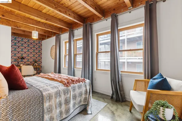a bedroom with a bed and glass window