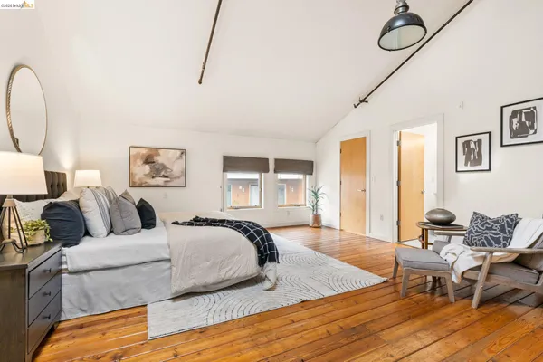 a bedroom with furniture and wooden floor