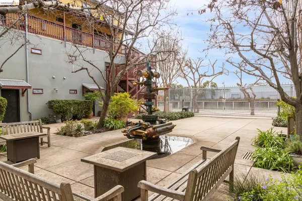 a view of a patio with couches table and chairs and potted plants