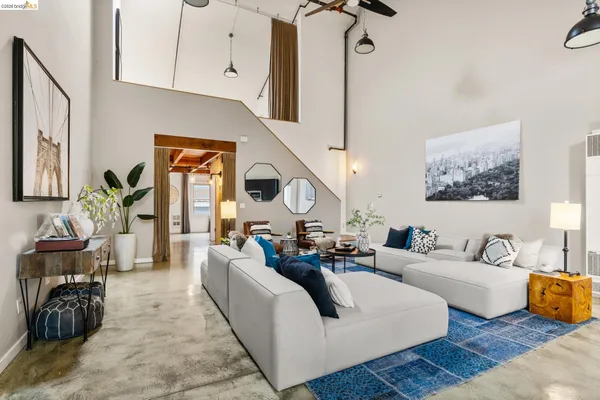 a living room with fireplace furniture and a wooden floor