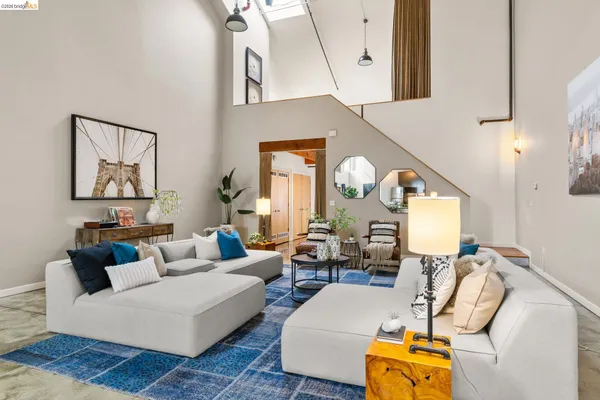 a living room with furniture and a large mirror