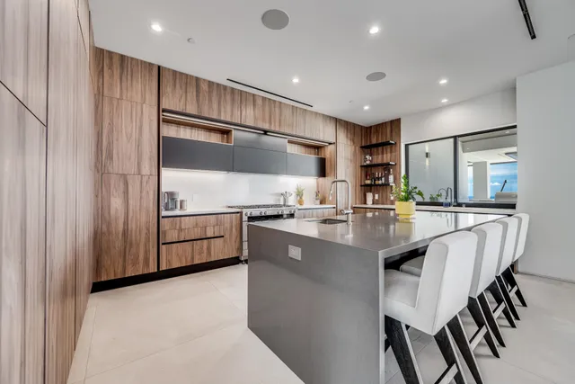 a kitchen with kitchen island a stove a sink and a refrigerator