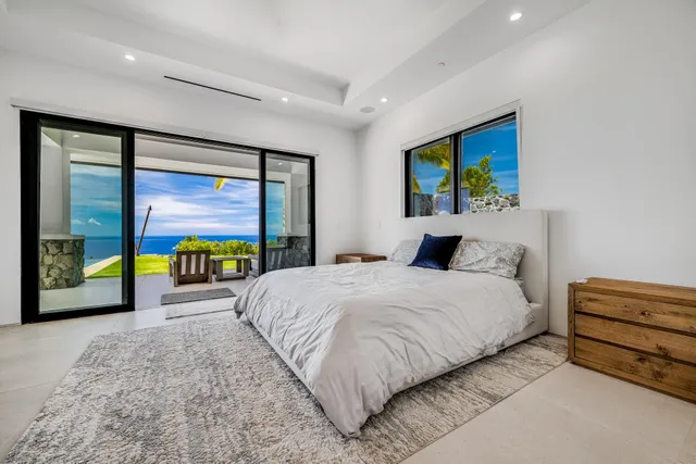 a spacious bedroom with a bed and a large window