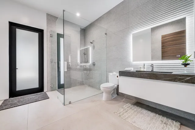 a bathroom with a toilet and shower