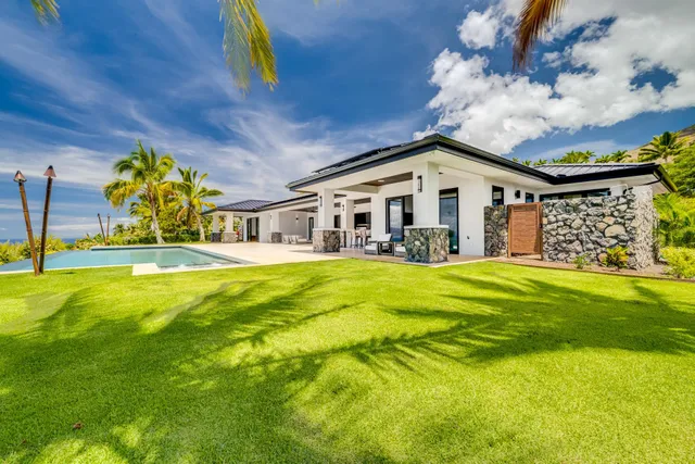 a view of swimming pool with outdoor seating and plants