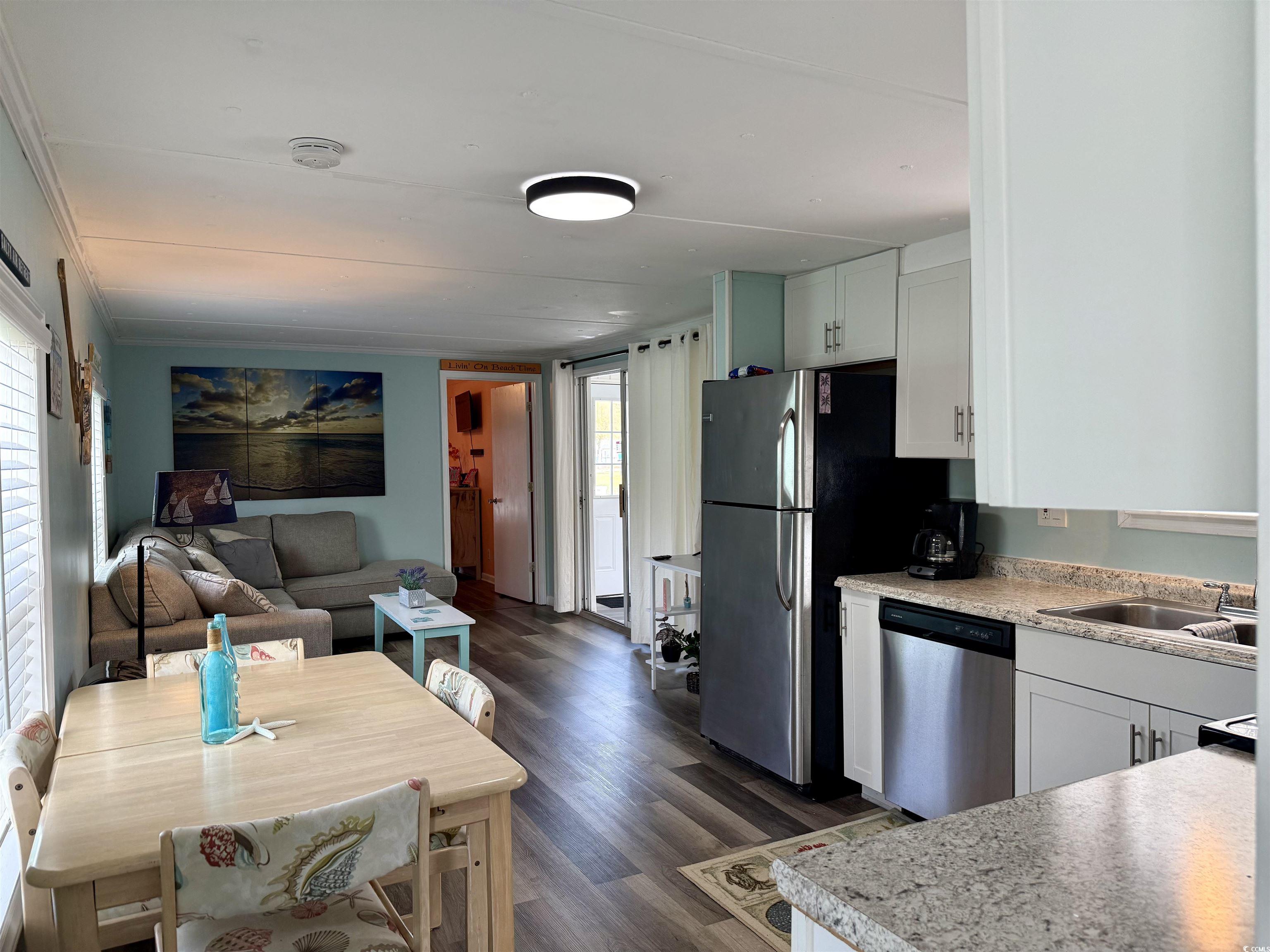272 Flamingo Surfside Beach, SC 29575 - Photo 12 of 39 Kitchen featuring light countertops, dark wood fin